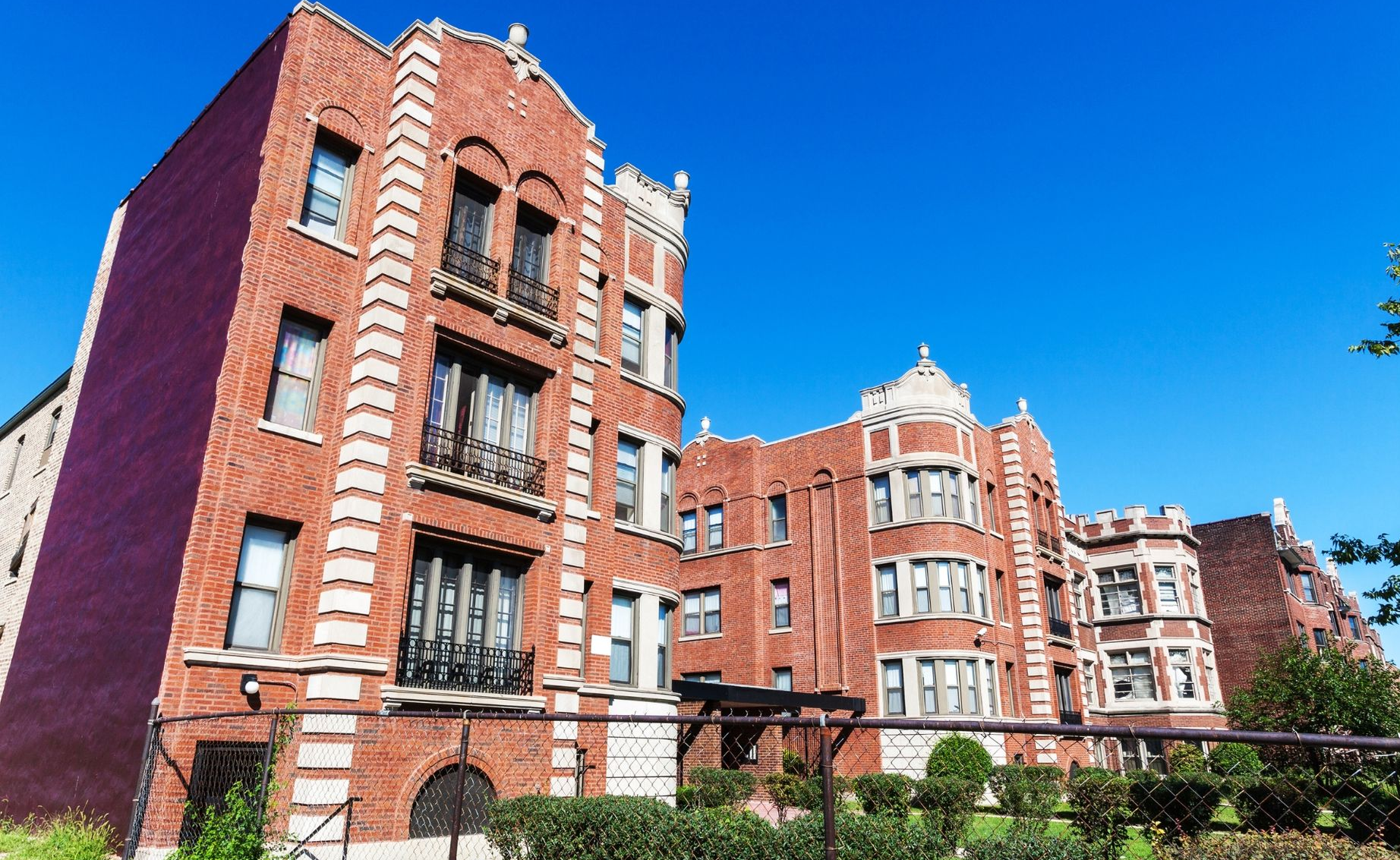 Red-brick apartment buildings with white trim