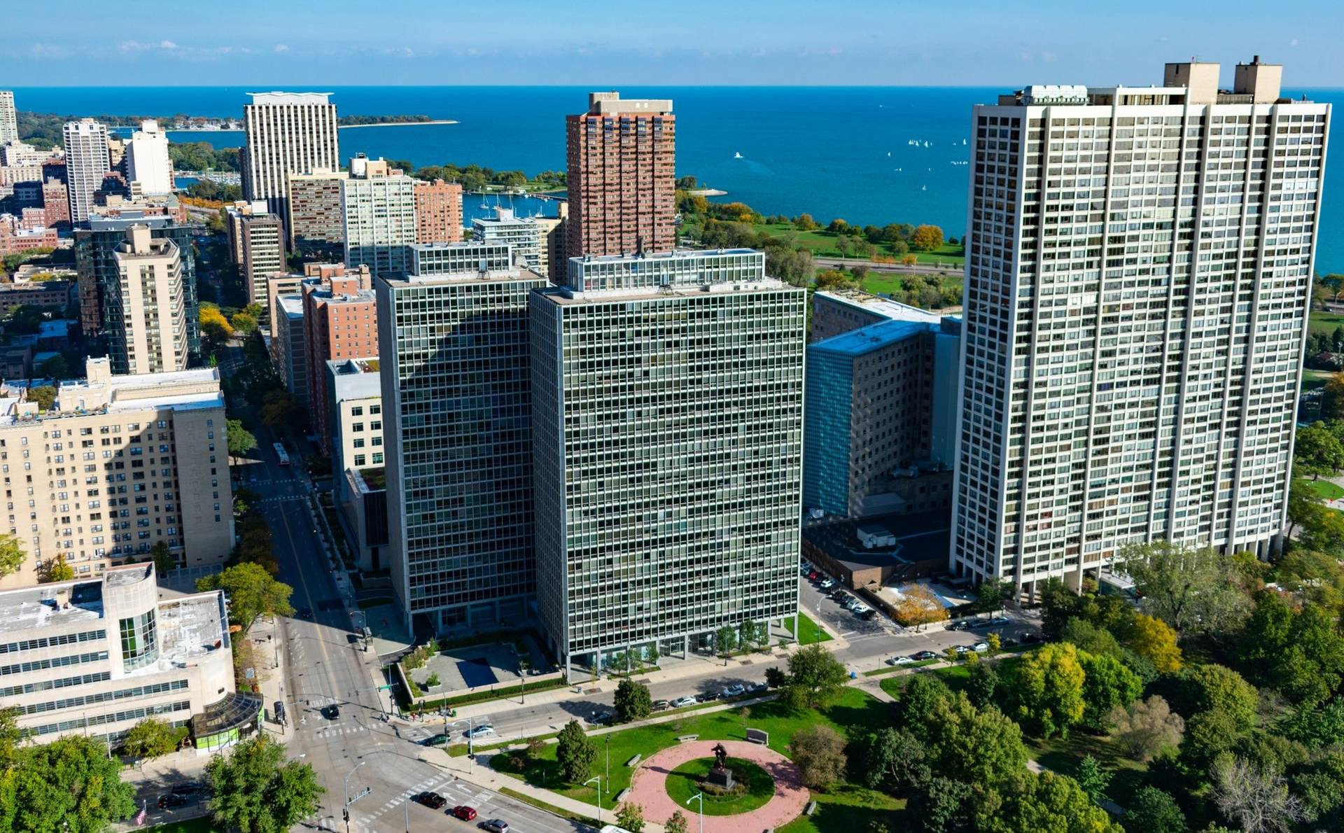 Downtown with tall modern buildings and a blue ocean backdrop