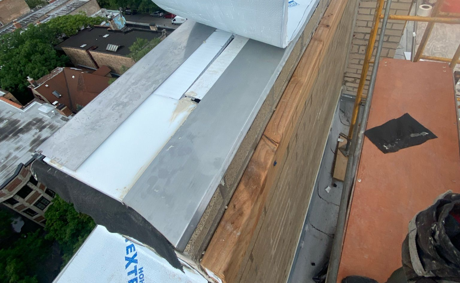Rooftop parapet wall with flashing and textroflash being installed
