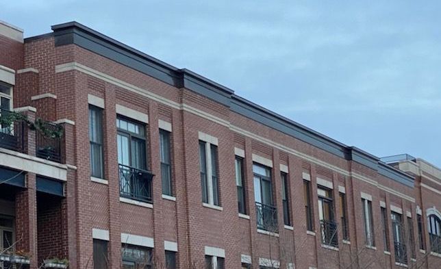 Custom designed vented metal cornice installed over Renaissance stone to protect it from rain and snow, Lakeview, Chicago