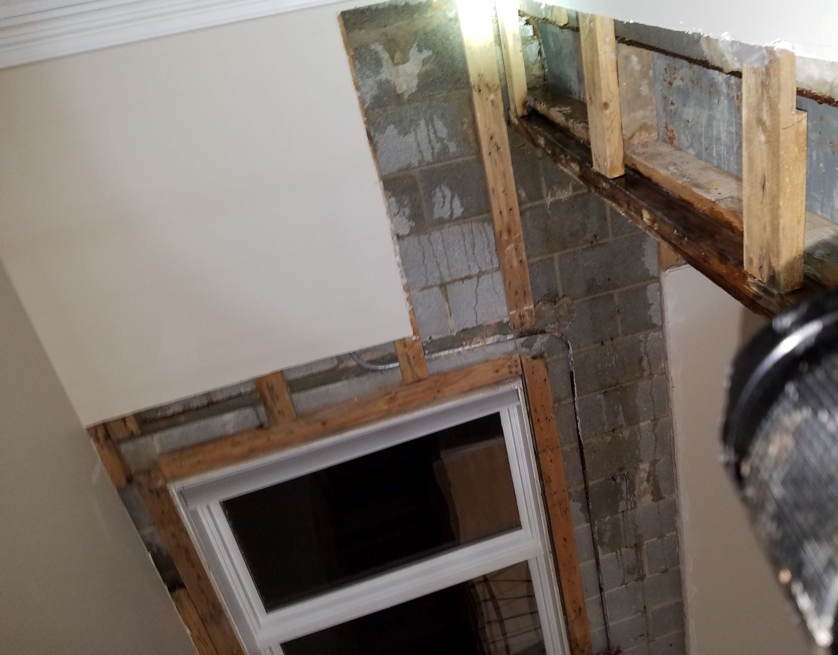 Water from skylight leak running down interior of concrete block exterior walls, Chicago