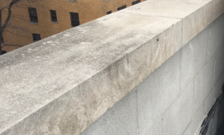 Concrete rooftop parapet wall