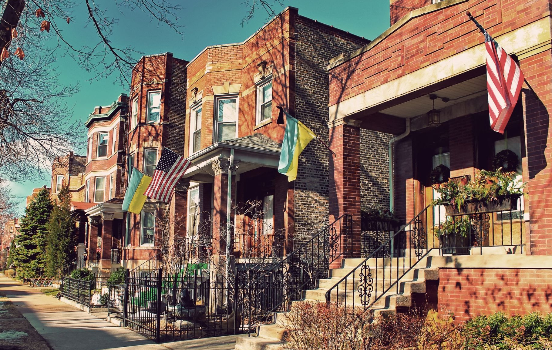 Brick rowhouses with stoops and black railings