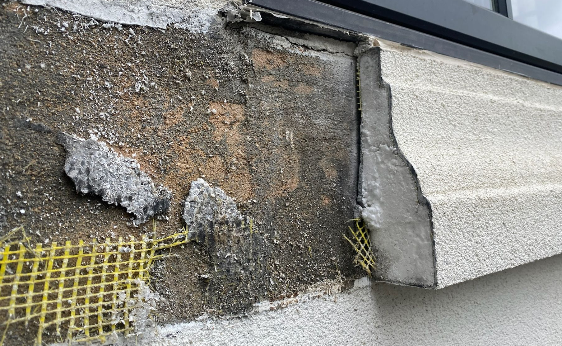 Damaged roof edge with cracked stucco