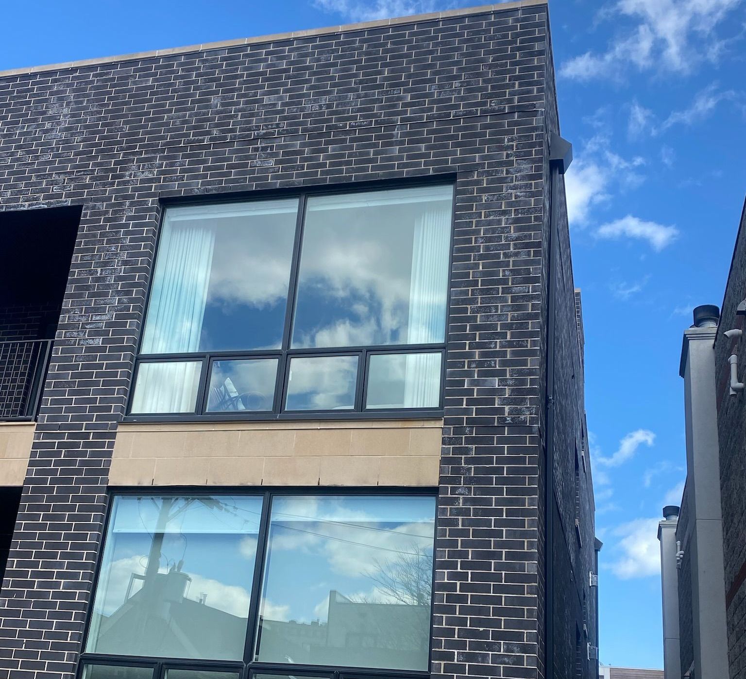 Large stacked picture windows with Renaissance Stone detail between window casuing leaks, Ukranian Village, Chicago