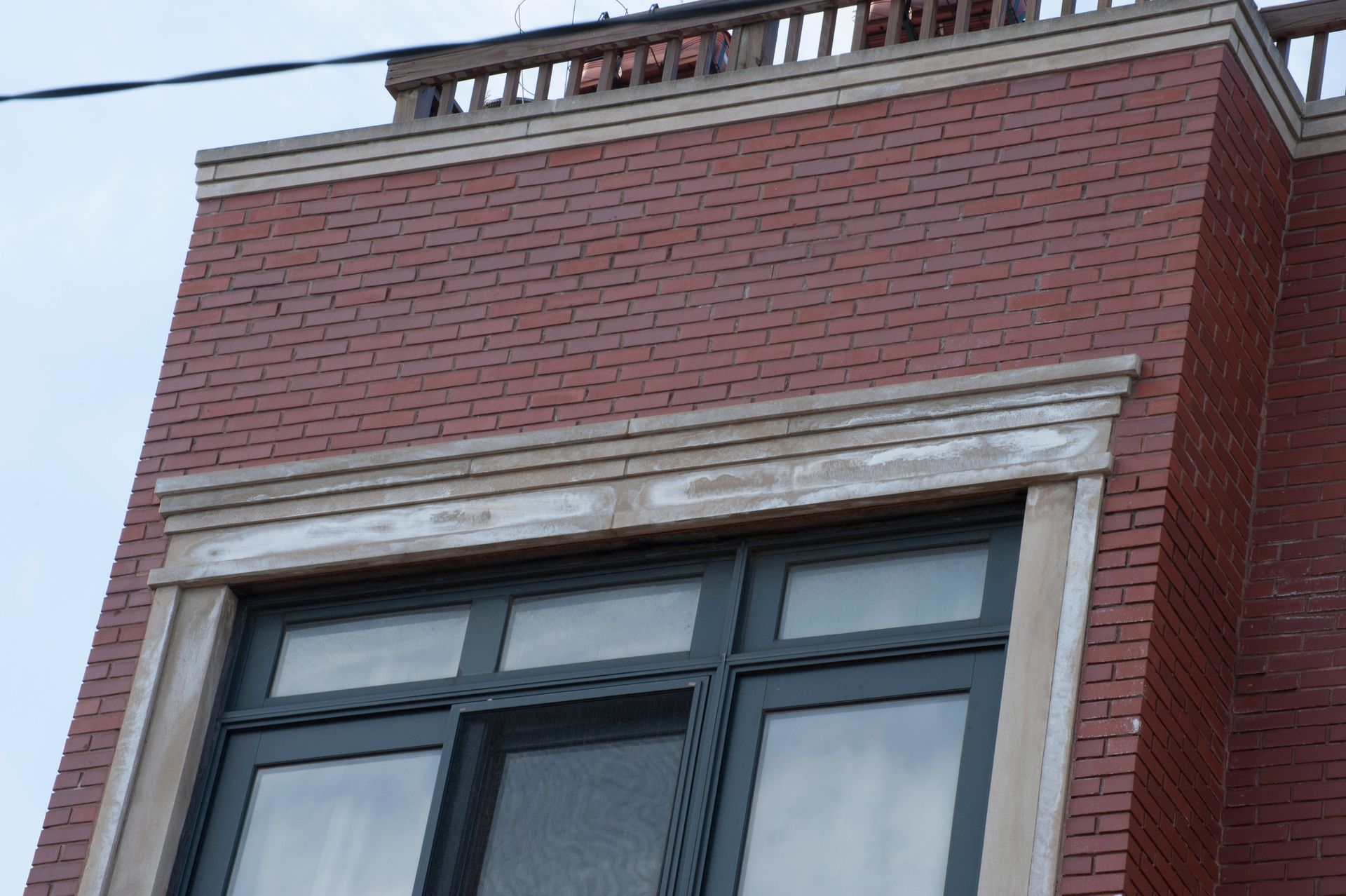 Wet Renaissance Stone window header detail showing efflorescence, Lincoln Park, Chicago