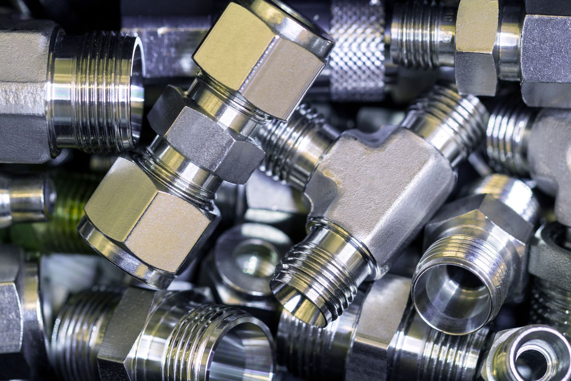 Hydraulic hoses and connectors on industrial machinery.