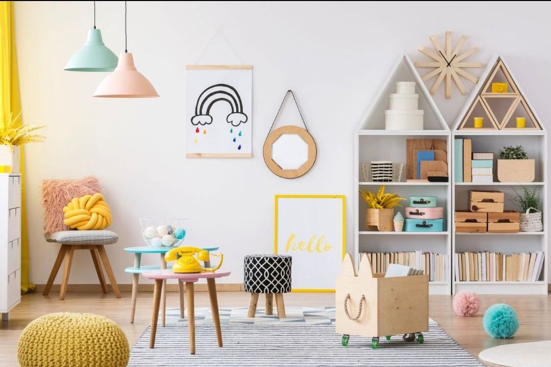A child 's room with a rainbow on the wall and a clock on the wall.