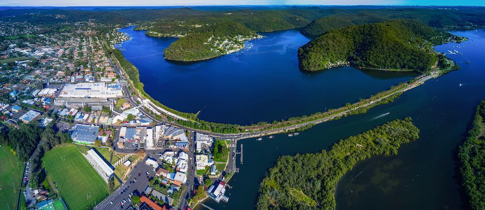 An Aerial View Of A Large Body Of Water Surrounded By Mountains And Trees — Newcastle Moving & Storage in Woy Woy, NSW