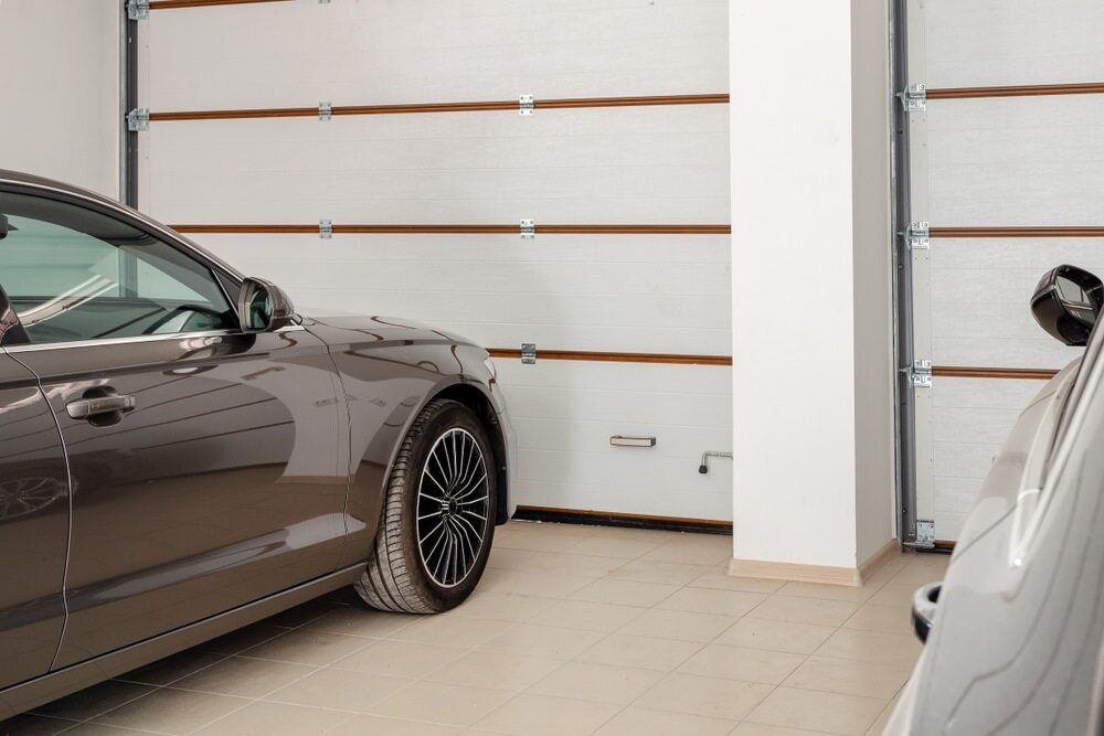 A Car Is Parked In A Garage Next To A Garage Door — Newcastle Moving & Storage in Salt Ash, NSW
