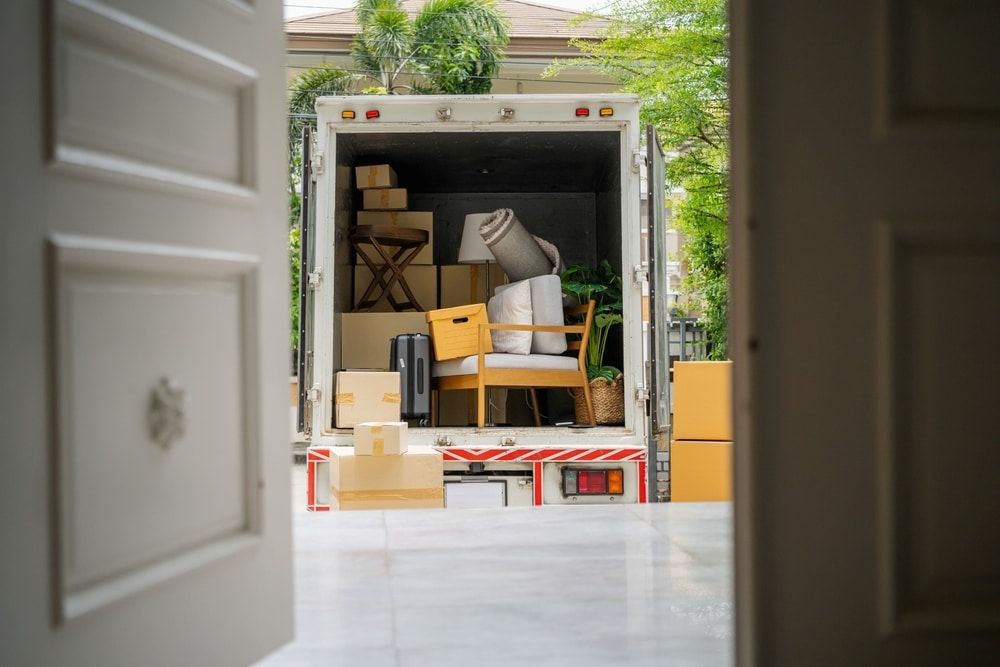 A Moving Truck Is Filled With Furniture And Boxes — Newcastle Moving & Storage in Rutherford, NSW