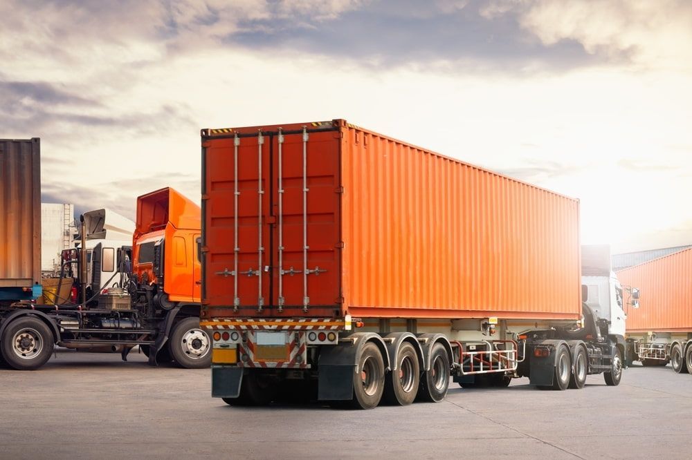 A Row Of Semi Trucks Are Parked Next To Each Other — Newcastle Moving & Storage in Salt Ash, NSW
