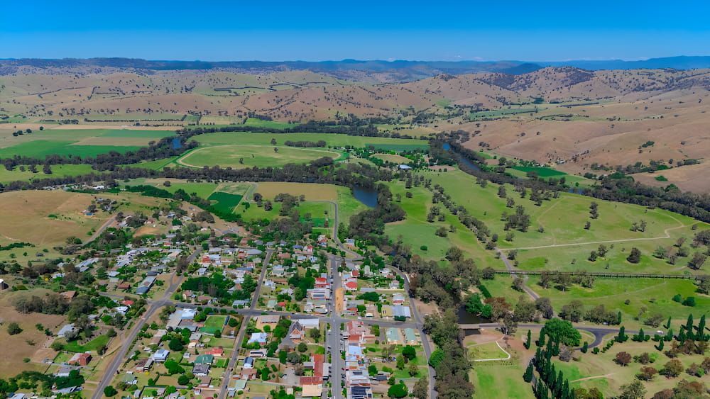 An Aerial View Of A Small Town Surrounded By Fields And A River — Newcastle Moving & Storage in Yarramalong, NSW