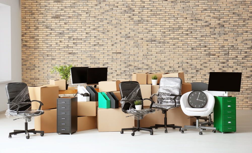 An Office Filled With Boxes, Chairs, Desks And Computers — Newcastle Moving & Storage in Woy Woy, NSW