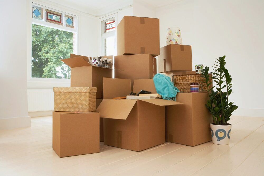 A Bunch Of Cardboard Boxes Are Stacked — Newcastle Moving & Storage in Salt Ash, NSW