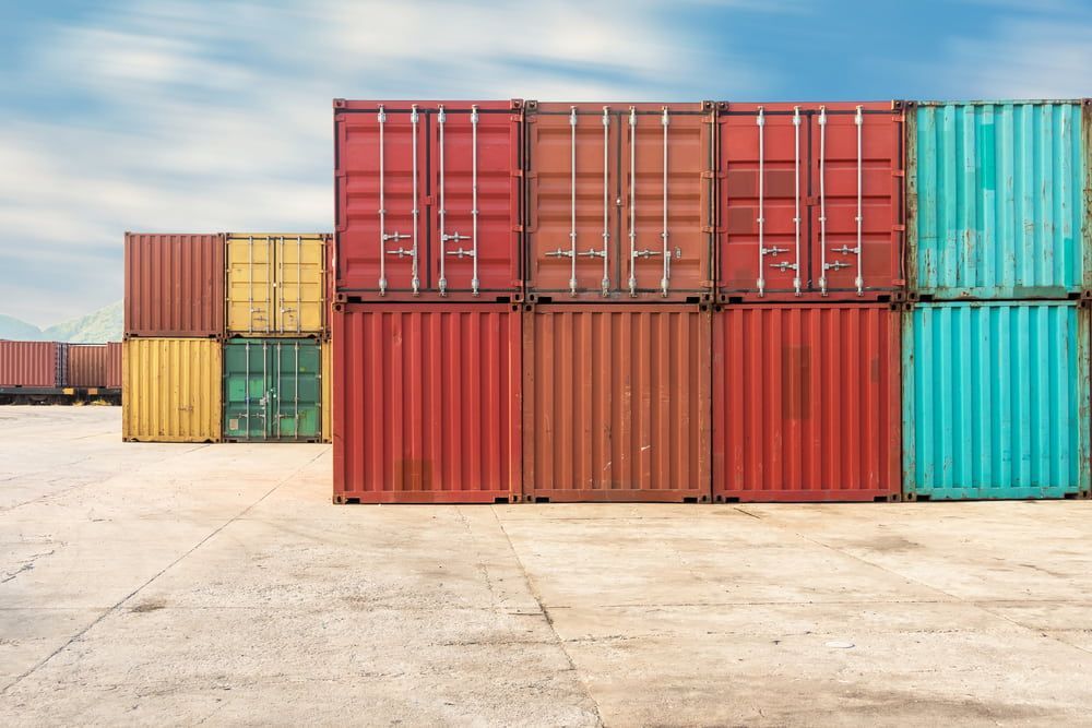 A Row Of Colourful Shipping Containers Stacked — Newcastle Moving & Storage in Salt Ash, NSW
