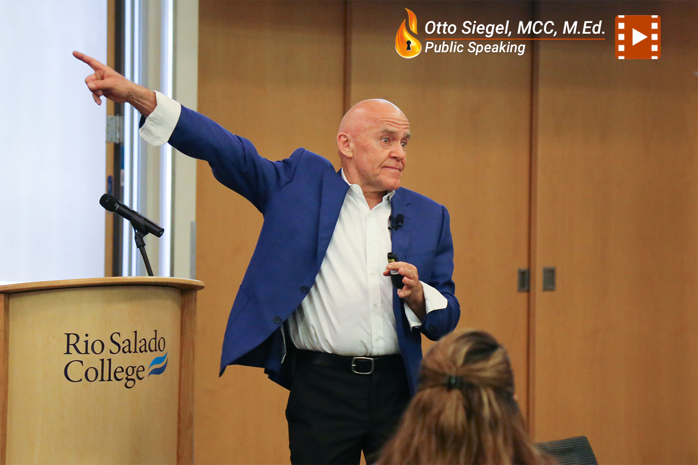 Man in blue jacket gestures during a presentation at Rio Salado College.