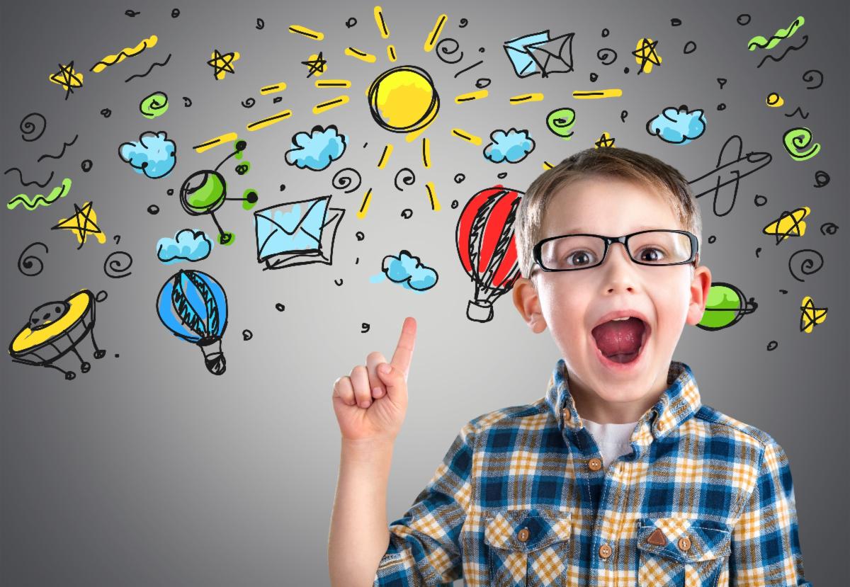 Boy wearing glasses, pointing up with an open mouth, surrounded by colorful doodles on a gray background.