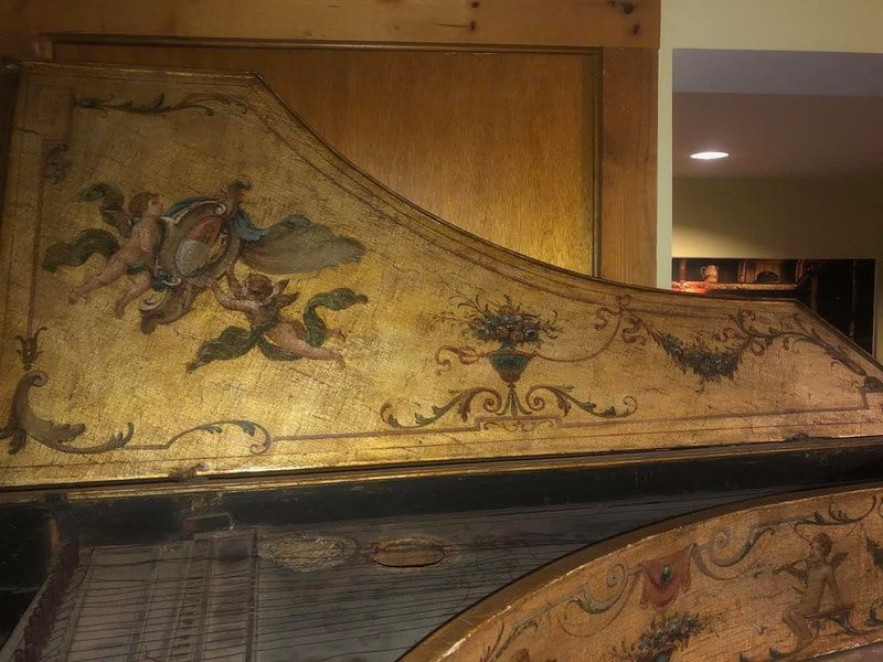 A wooden wall with a painting of angels on it