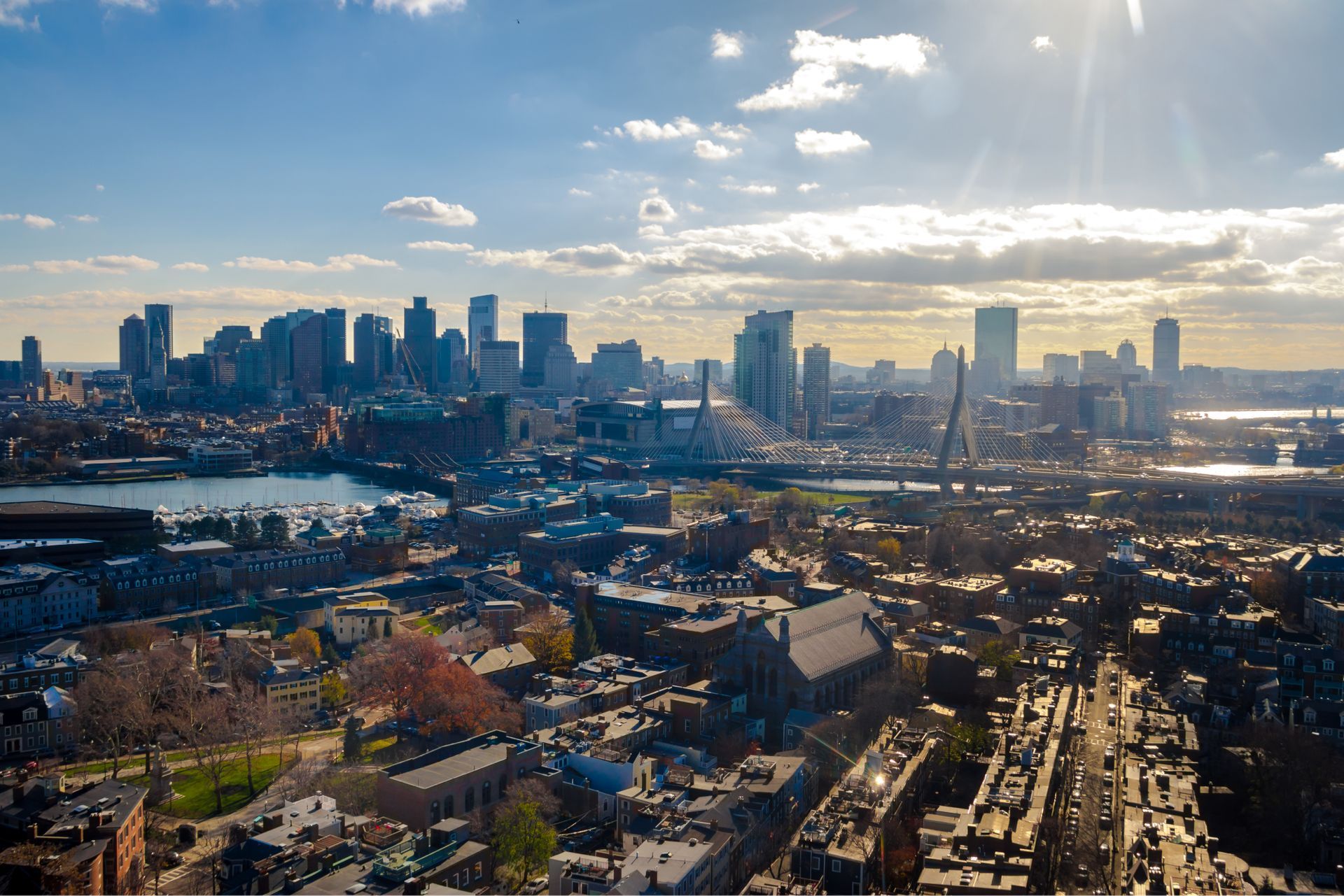 An aerial view of a city skyline with a river in the foreground.