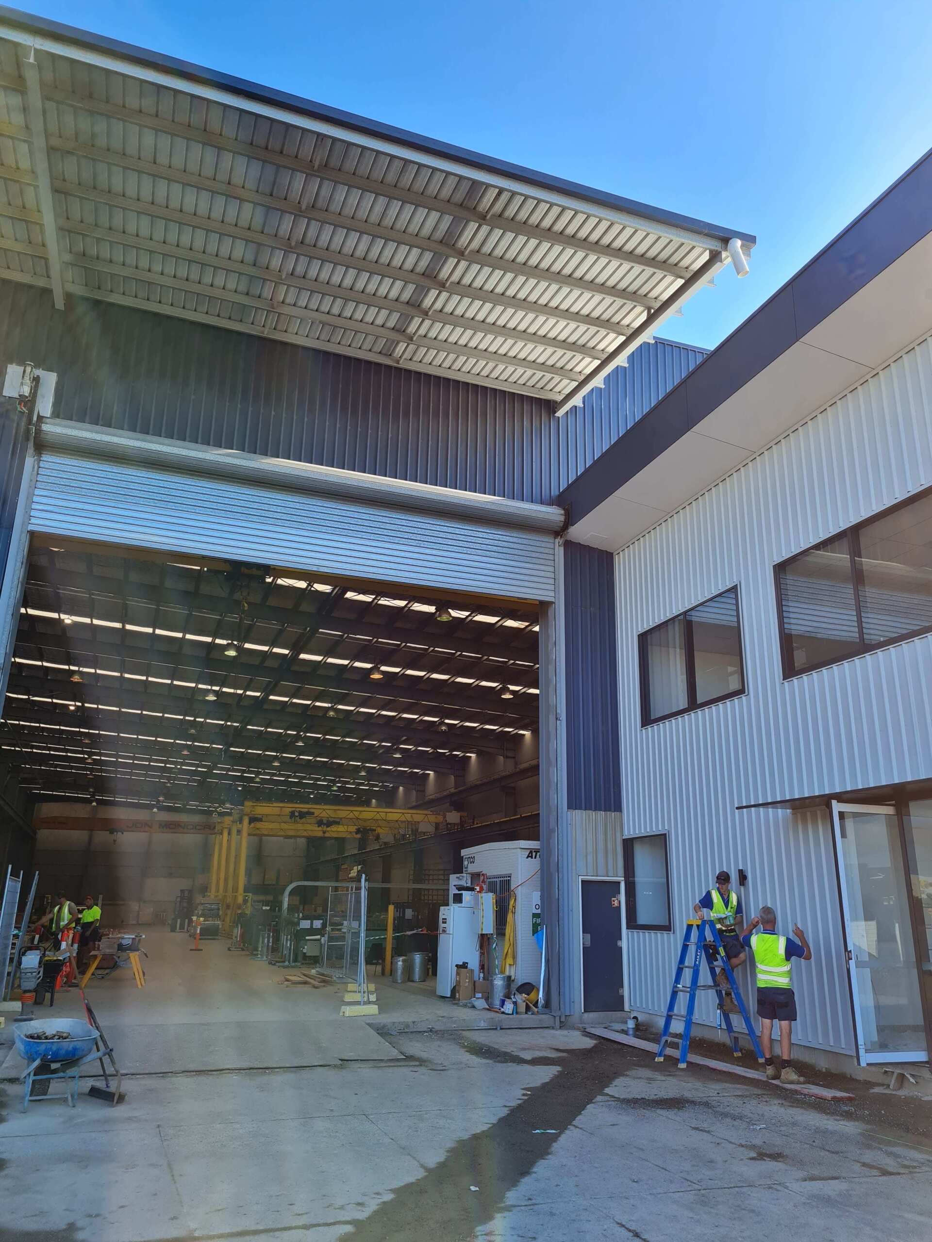 A group of people are working on the side of a building.