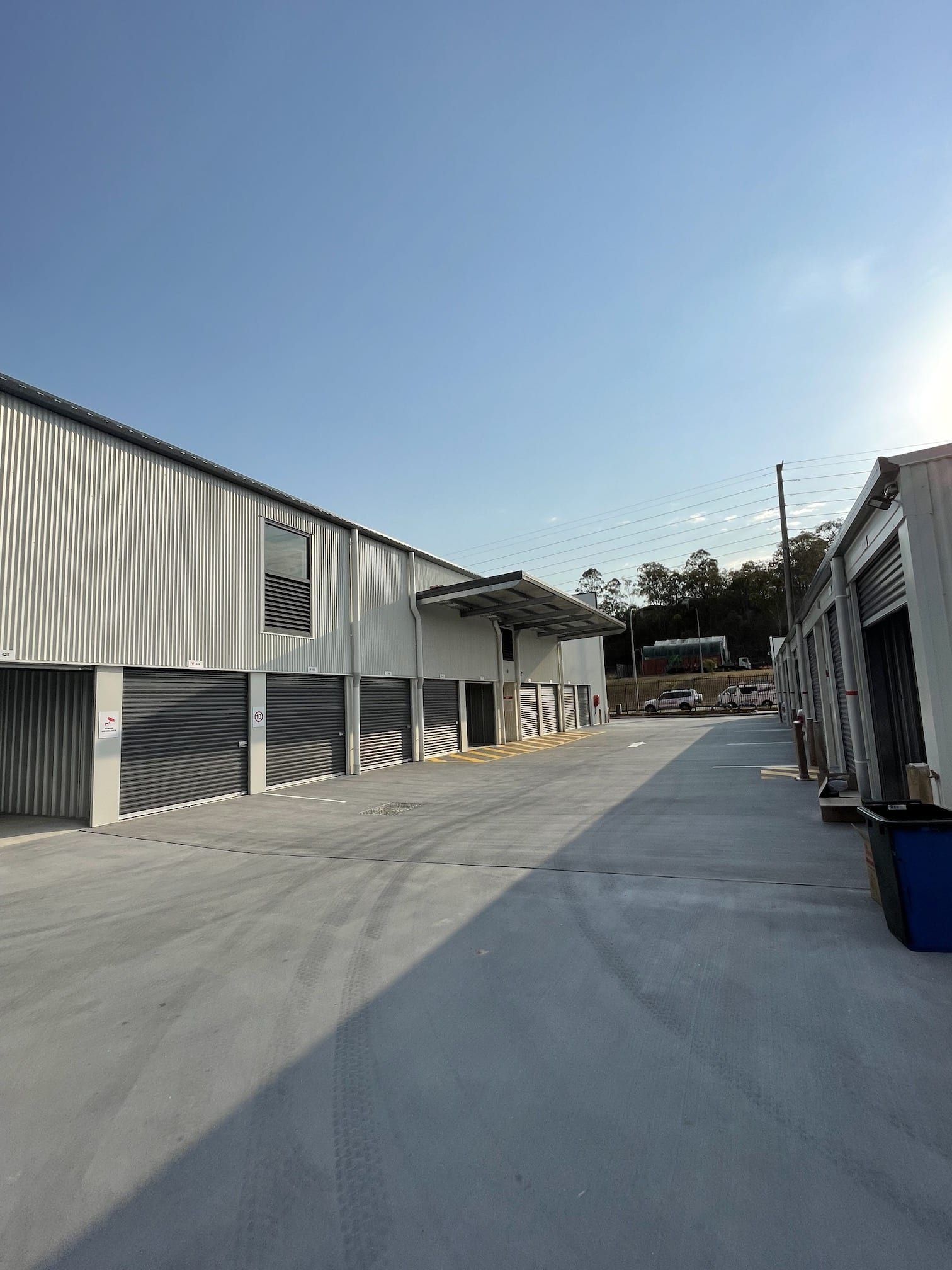 A row of warehouses with a blue sky in the background.