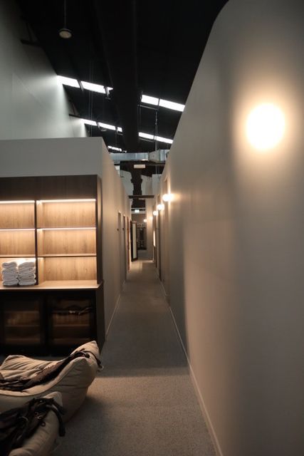 A long hallway with a chair in the middle of it