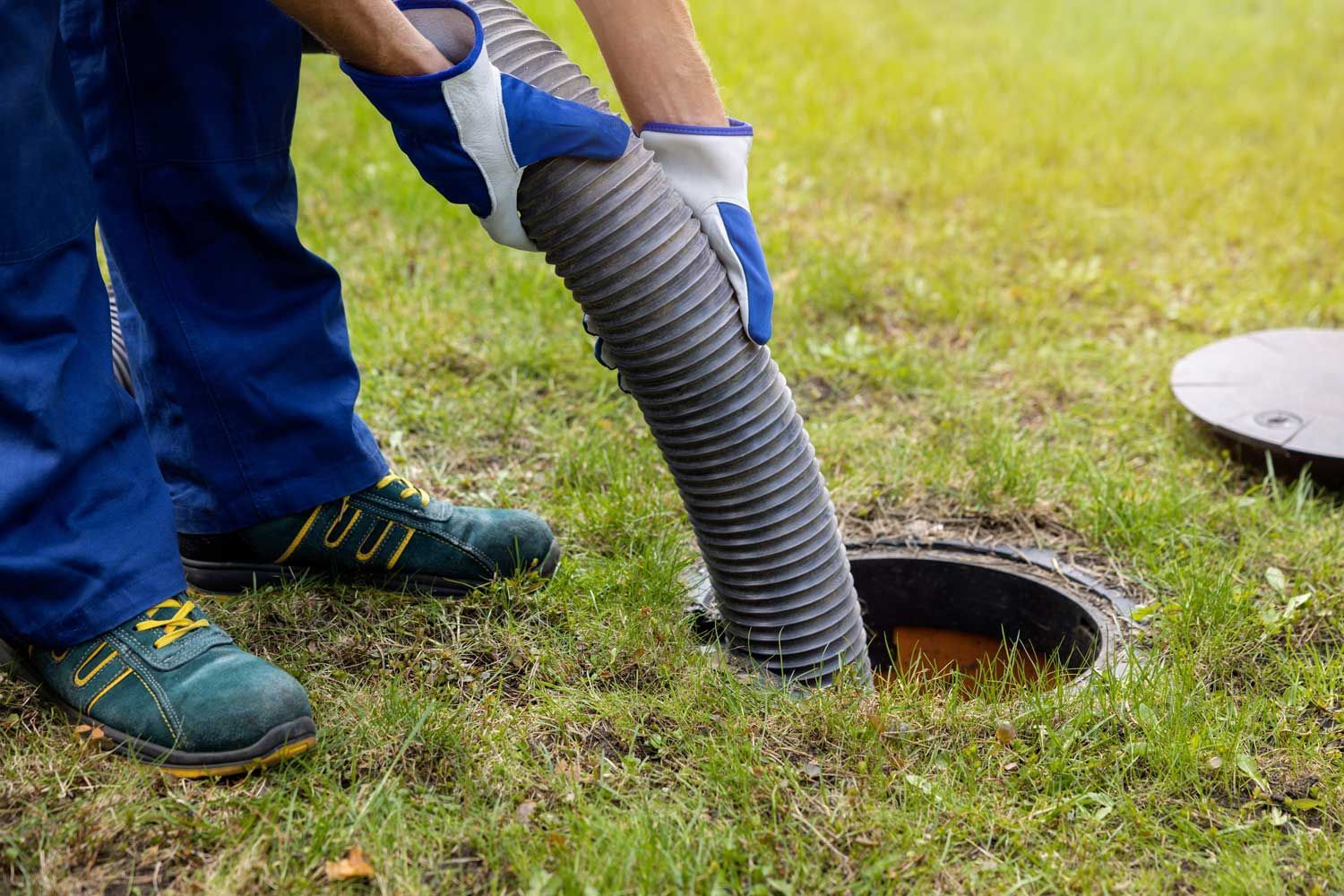 A man is cleaning a septic tank.