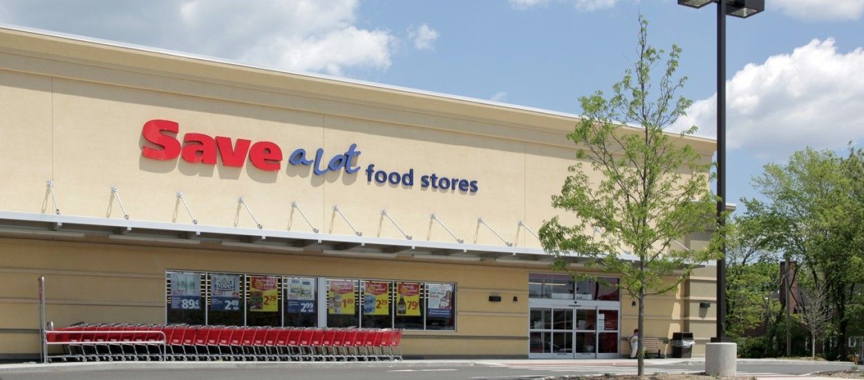 Save-A-Lot grocery store exterior with beige facade, red sign, and shopping carts in front