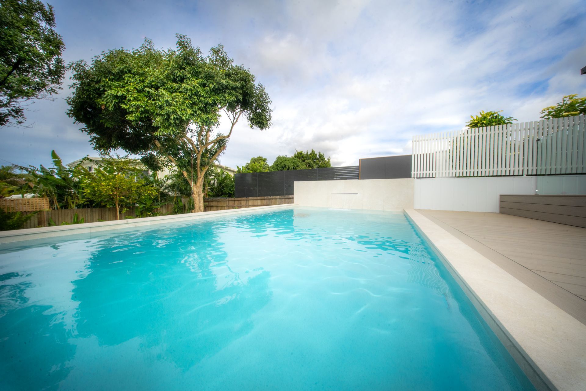 Backyard With Pool, Patio, House, and Blue Sky — Concrete Pool Projects in River Ranch, QLD