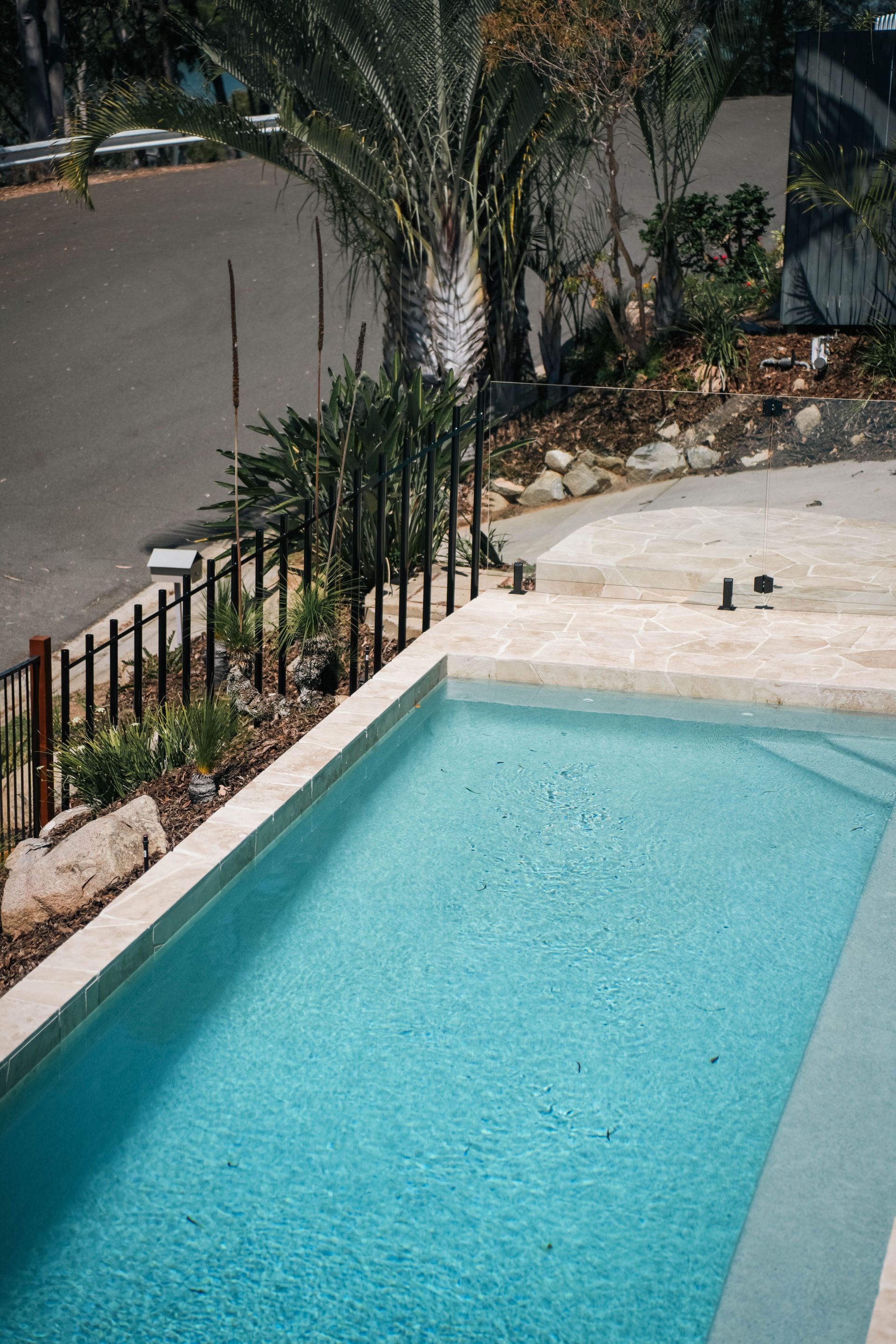 Blue Pool With Landscaping — Concrete Pool Projects in Gladstone Central, QLD