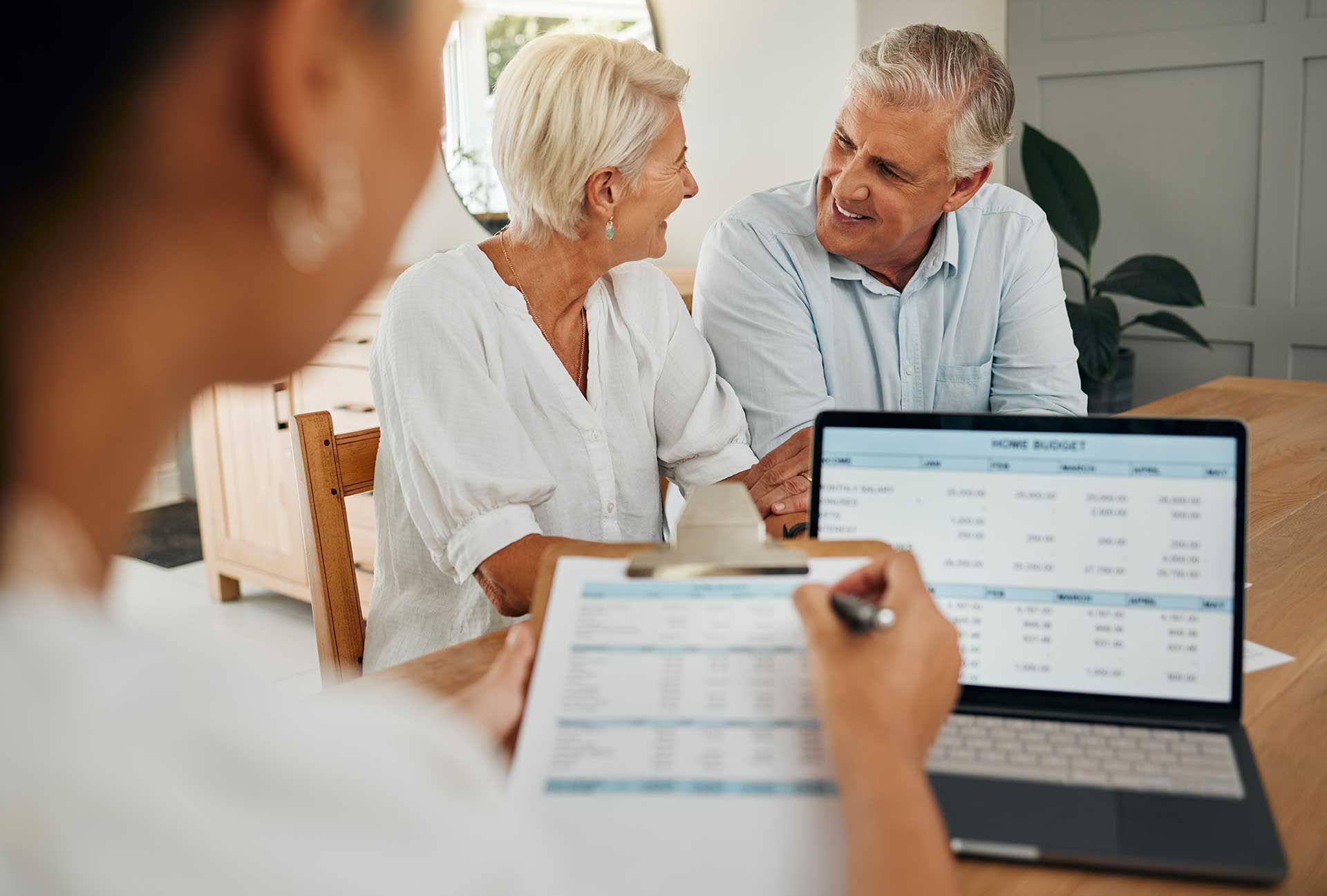 Senior couple, laptop and financial advisor in retirement finance planning paper, budget loan or investment insurance documents.