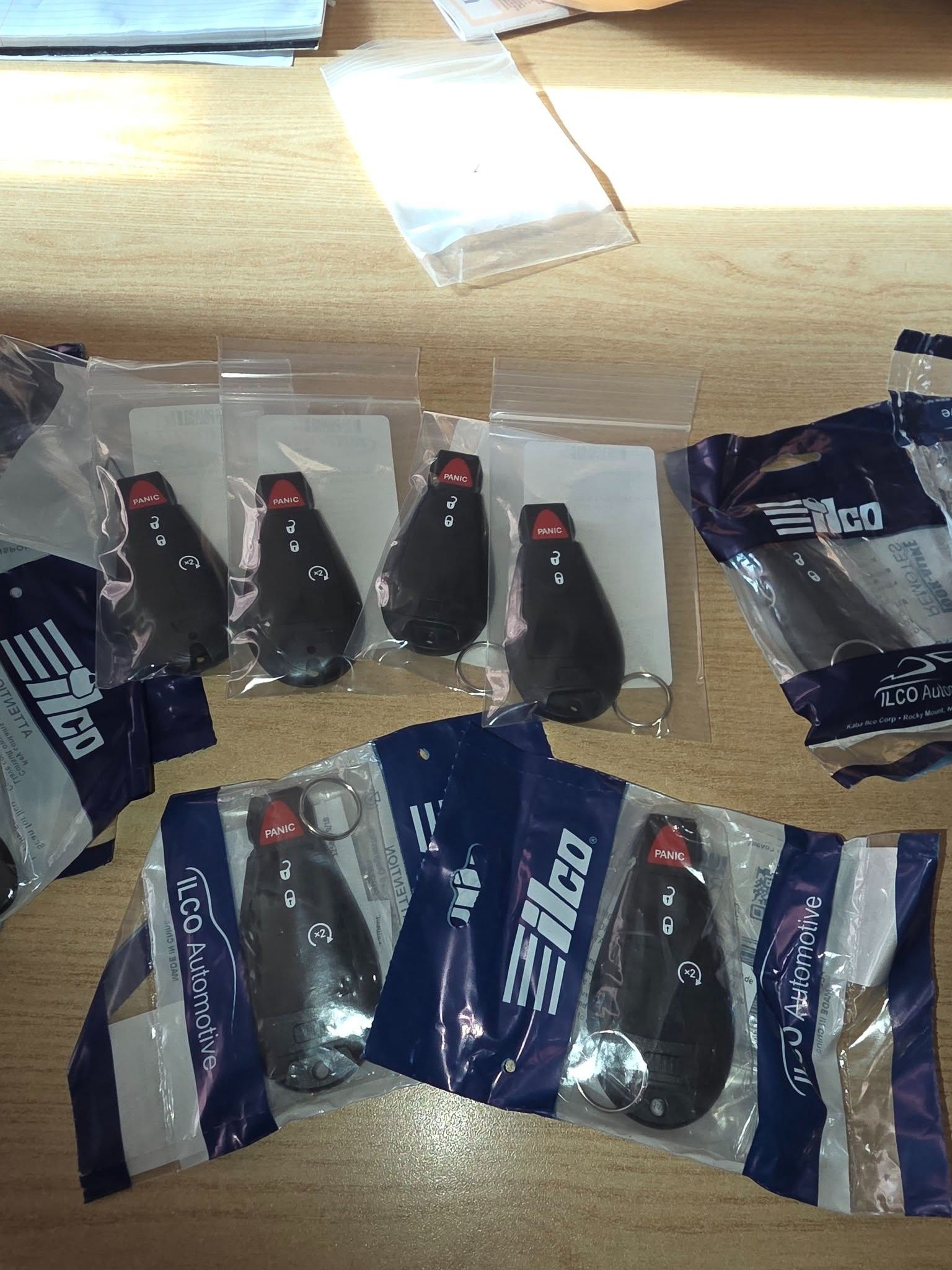 Assorted black and red packaged items arranged on a wooden surface with clear and dark blue wrappers.