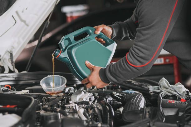 Man Pouring Oil — Mechanics in Ballarat