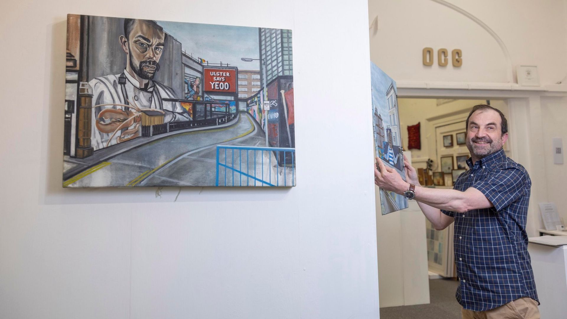 Gallerist Olivier Cornet presenting David Fox's work for a photo shoot with photographer Fergal Phillips. This photo featured in 