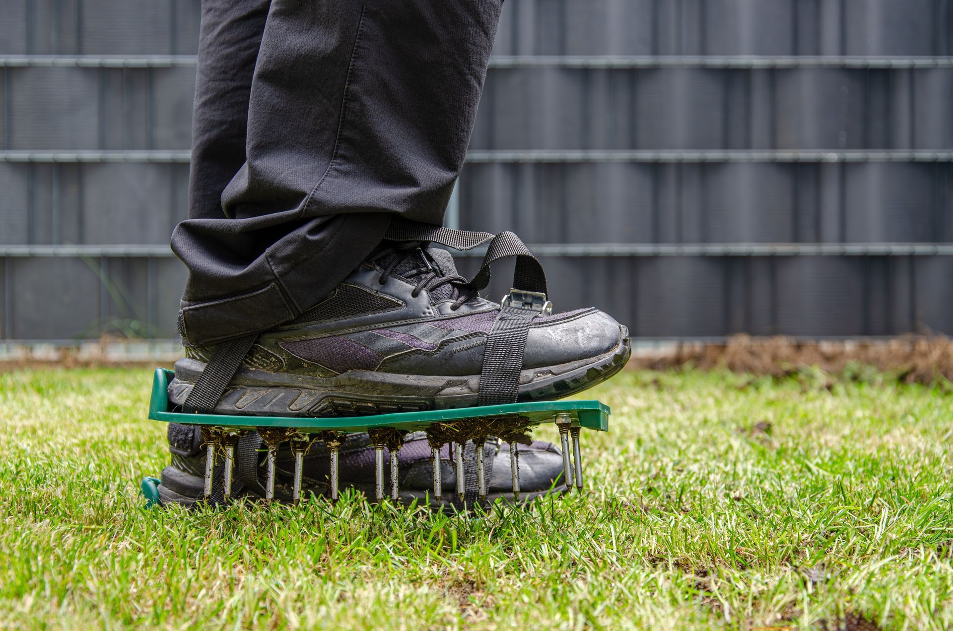 Shoes standing on a spring-loaded exercise board on grass outdoors