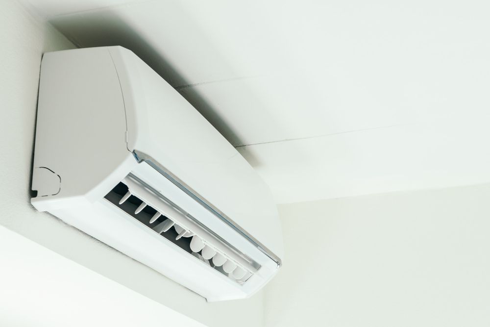 a white air conditioner is mounted on a white wall