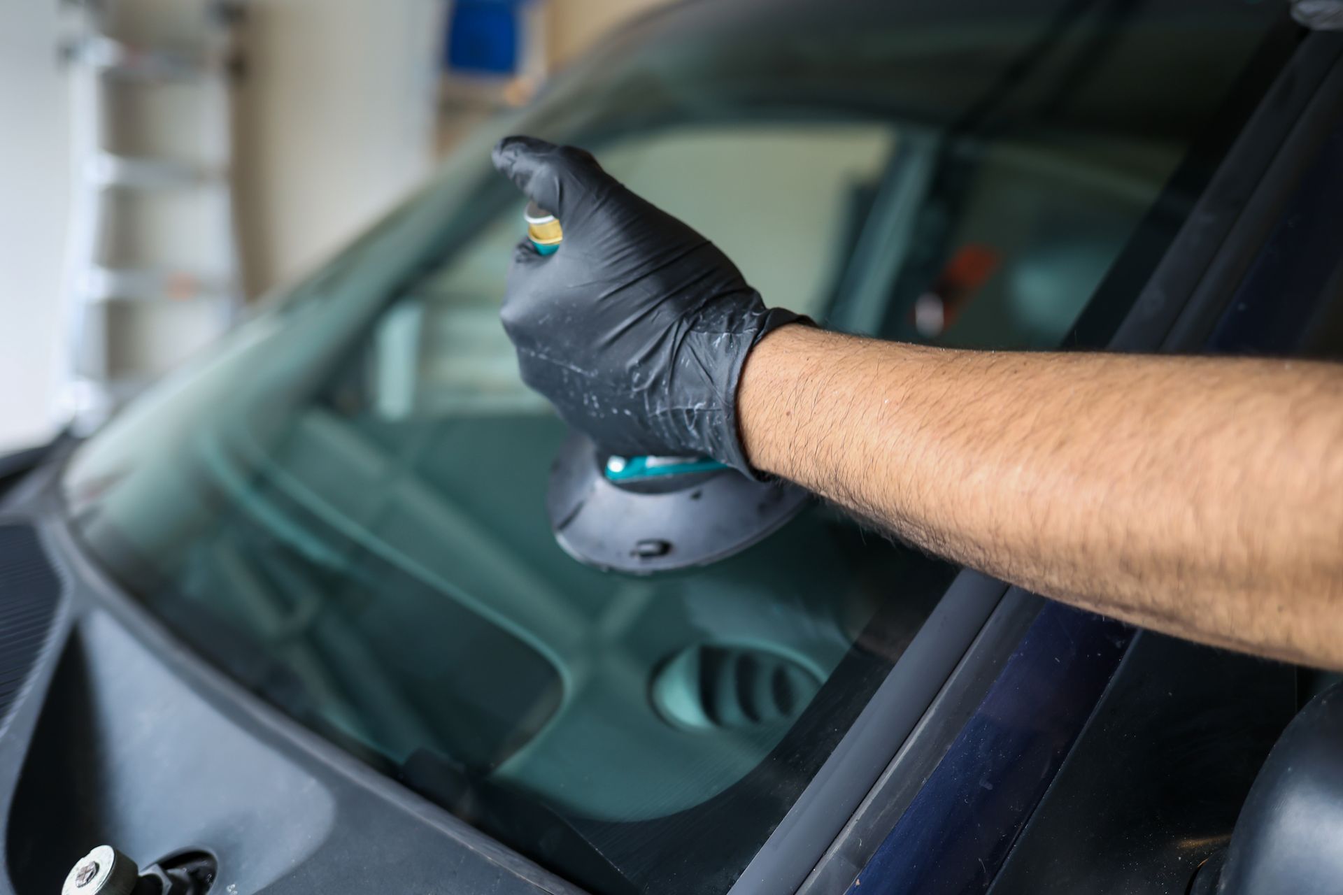 A man is working on a windscreen replacement. A man is working on a windscreen replacement.
