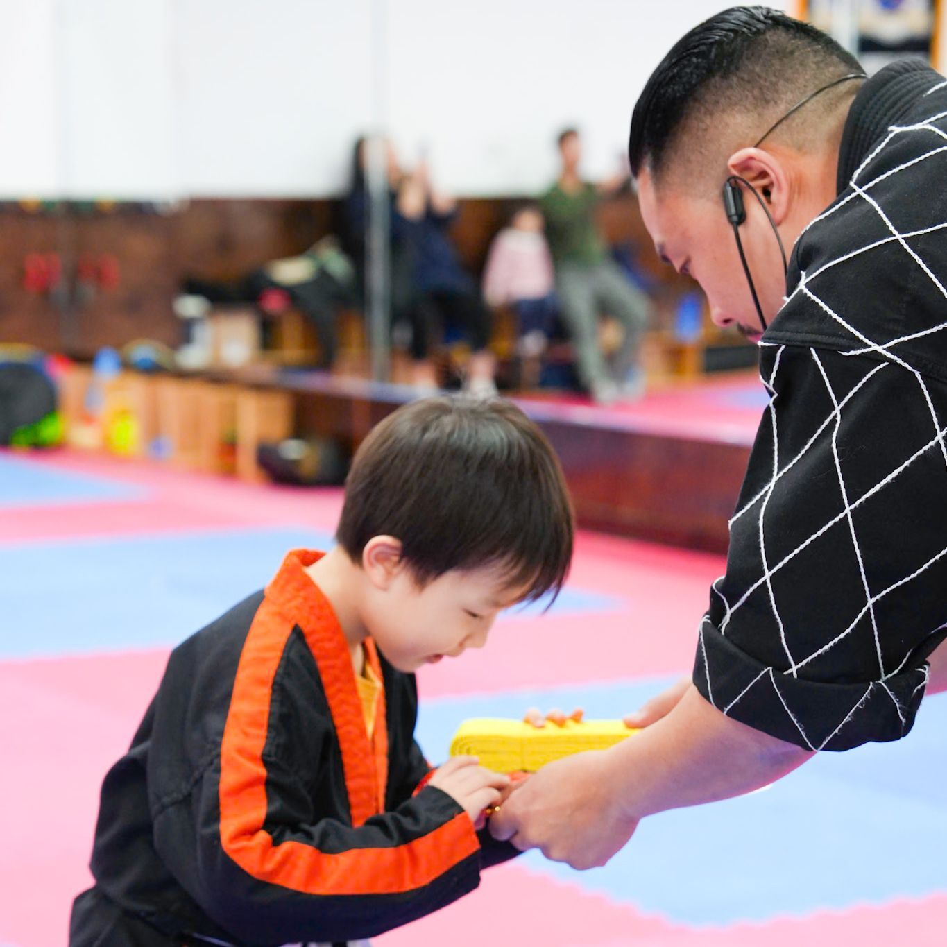 A man is giving a gift to a young boy