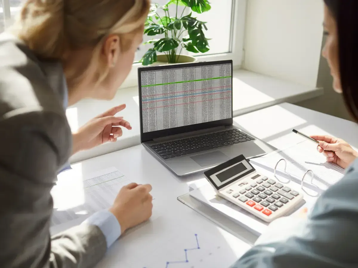 Insurance accountant discussing spreadsheet data to provide key accounting insights to a client.