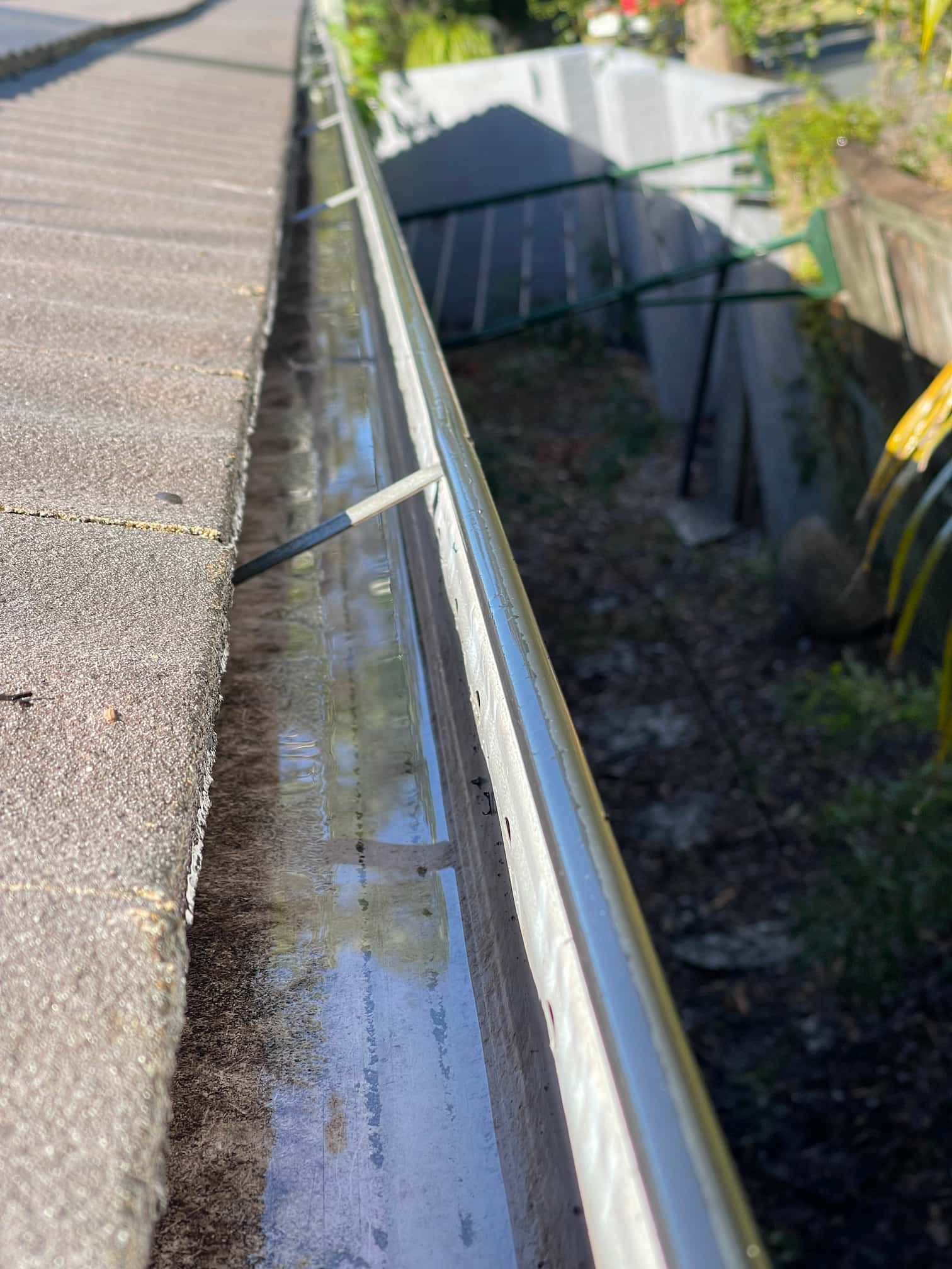 a gutter on a roof with a hose attached to it