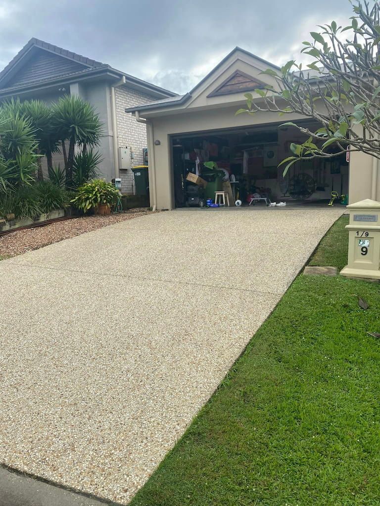a pressure cleaned driveway leading to a house with a mailbox that has the number 9 on it