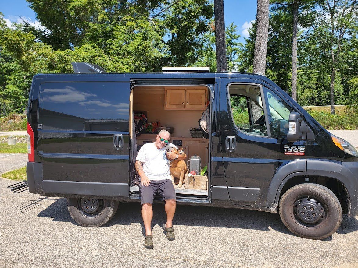Man And Dog Sitting In A Camper Van  - Milton, NH  - RV Service and R & L Van Builds