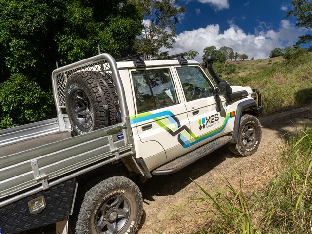 A White Truck on a Dirt Road — Lacey's TJM 4X4 Megastore in Rockhampton City, QLD