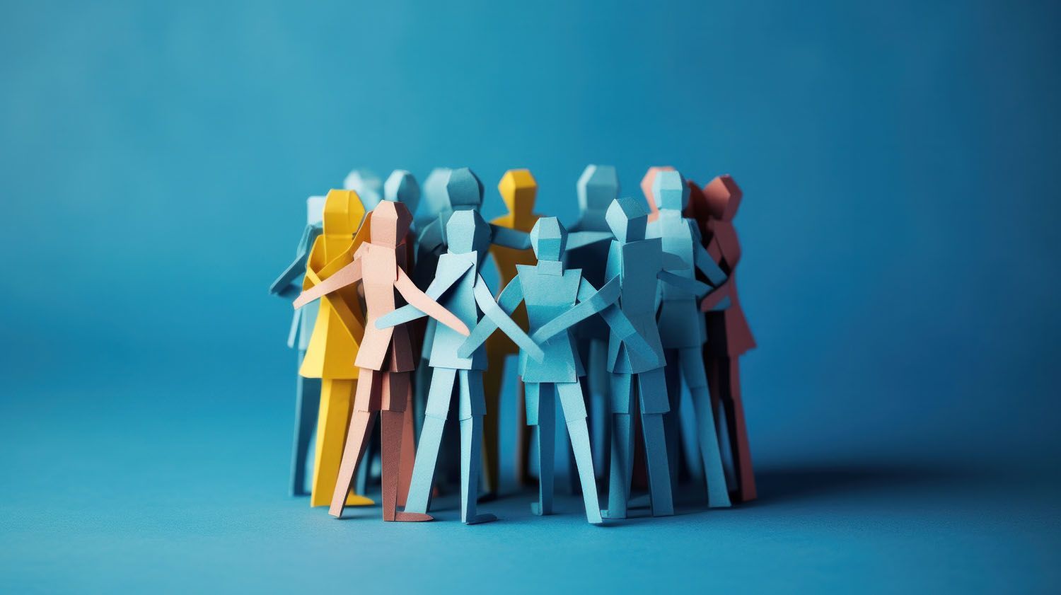 Paper cutouts of people in a circle, holding hands.