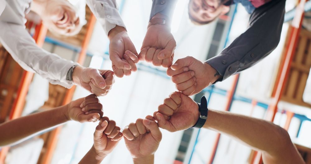 A group of people are holding hands in a circle.