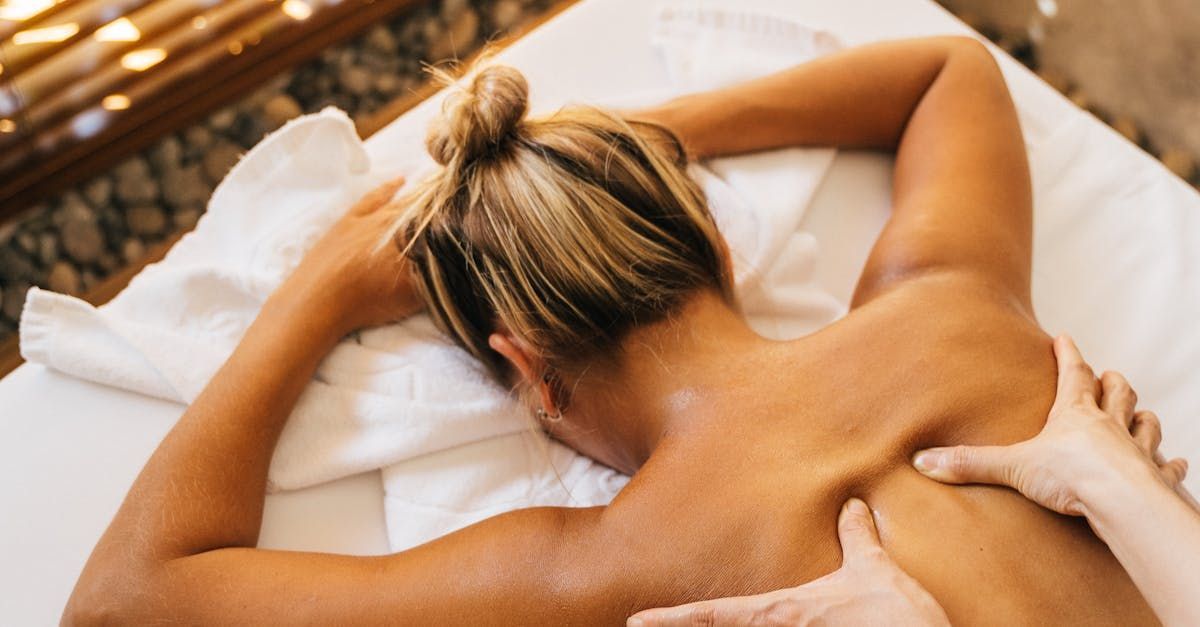 A woman is getting a massage on her back at a spa.