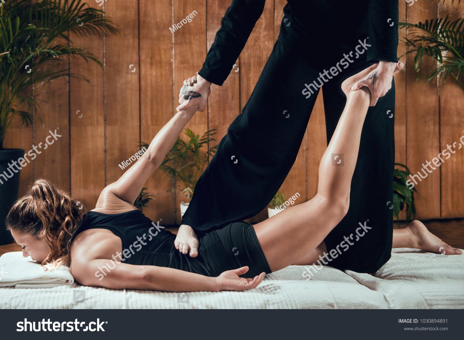 A woman is getting a massage on her back at a spa.