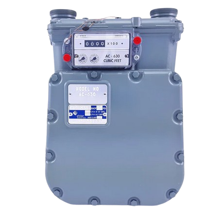 A gray AC630 gas meter with a digital display showing readings. It is mounted on a wall outdoors.