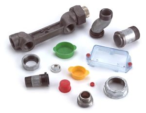 Various metal pipe fittings and protective caps in a white setting. Some fittings are angled, others are tubular or cast with holes.